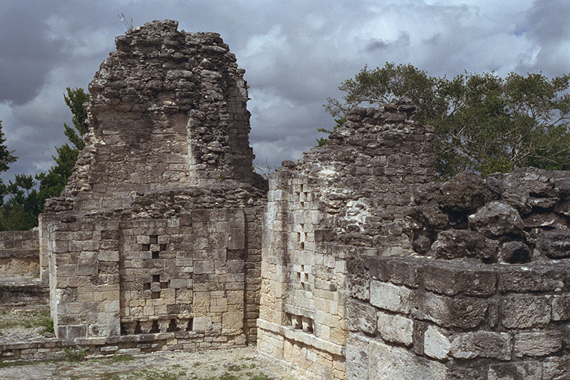 Becán: Str. IV residential courtyard showing collapsed vaults and the exterior stair to ground level
