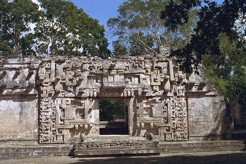 The iconic 'Monster Mouth' facade of Structure II at Chicanná, representing the reptilian creator god Itzamna