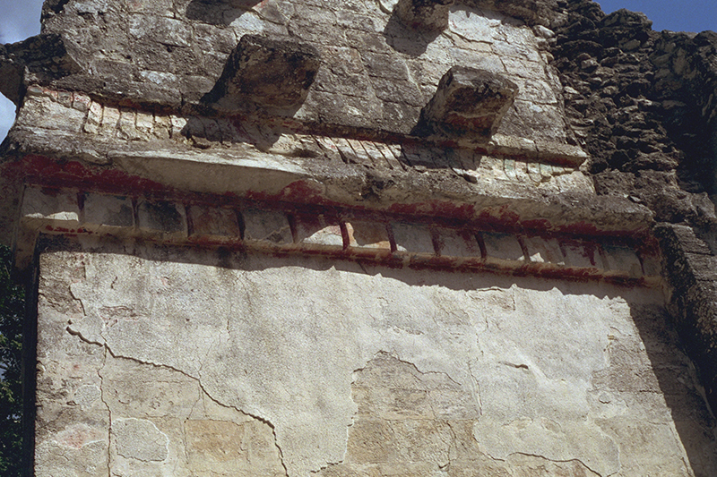Close-up of the facade showing vibrant traces of original pigment on the stone sculpture