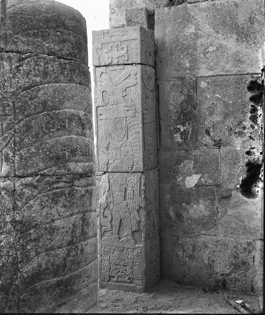 1889 photo looking outward from Jaguar Temple showing serpent columns and carved door jambs