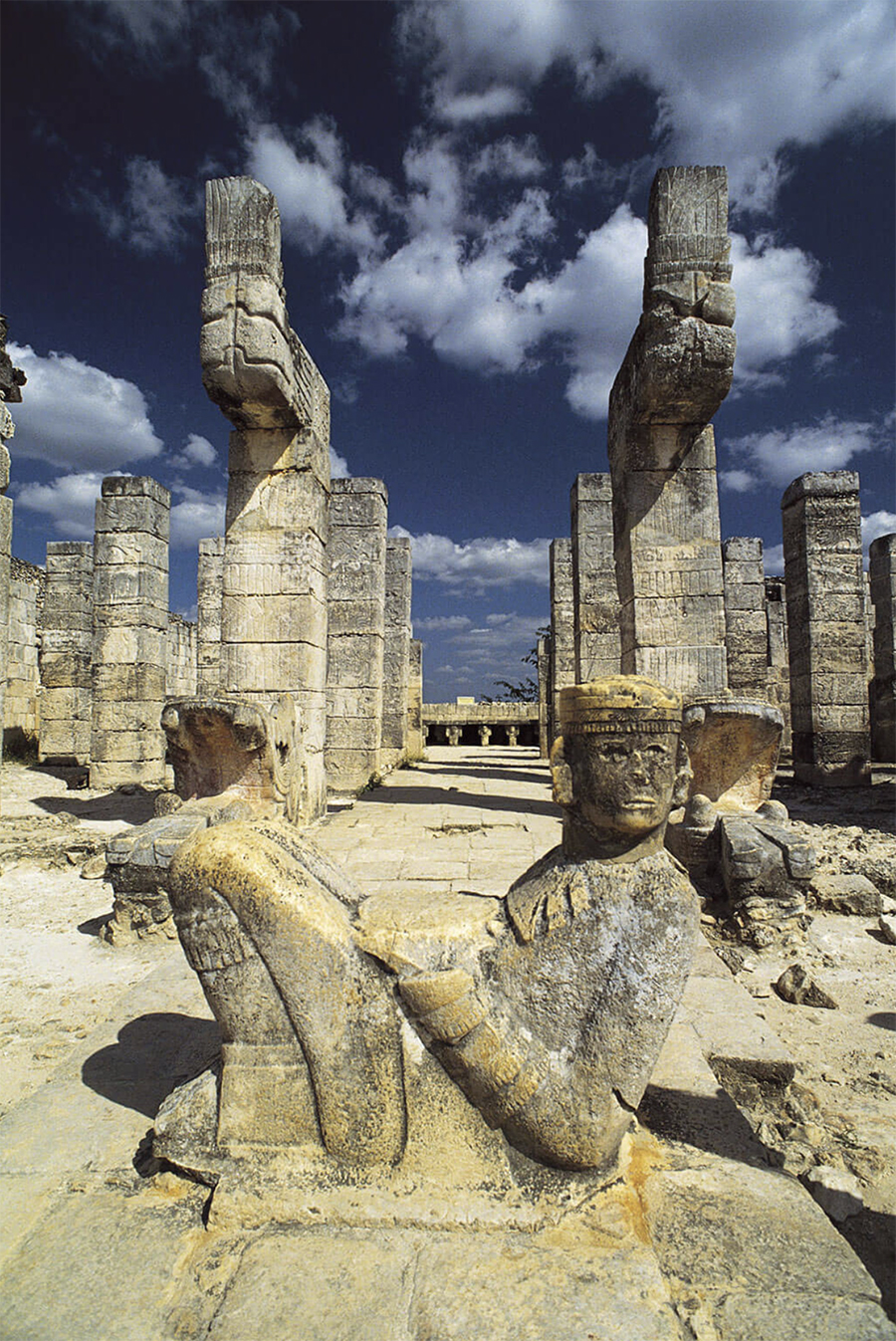 Government of Mexico photo of the restored Temple of the Warriors: Chac Mool, restored serpent columns, restored rectangular columns, Atlantean altar