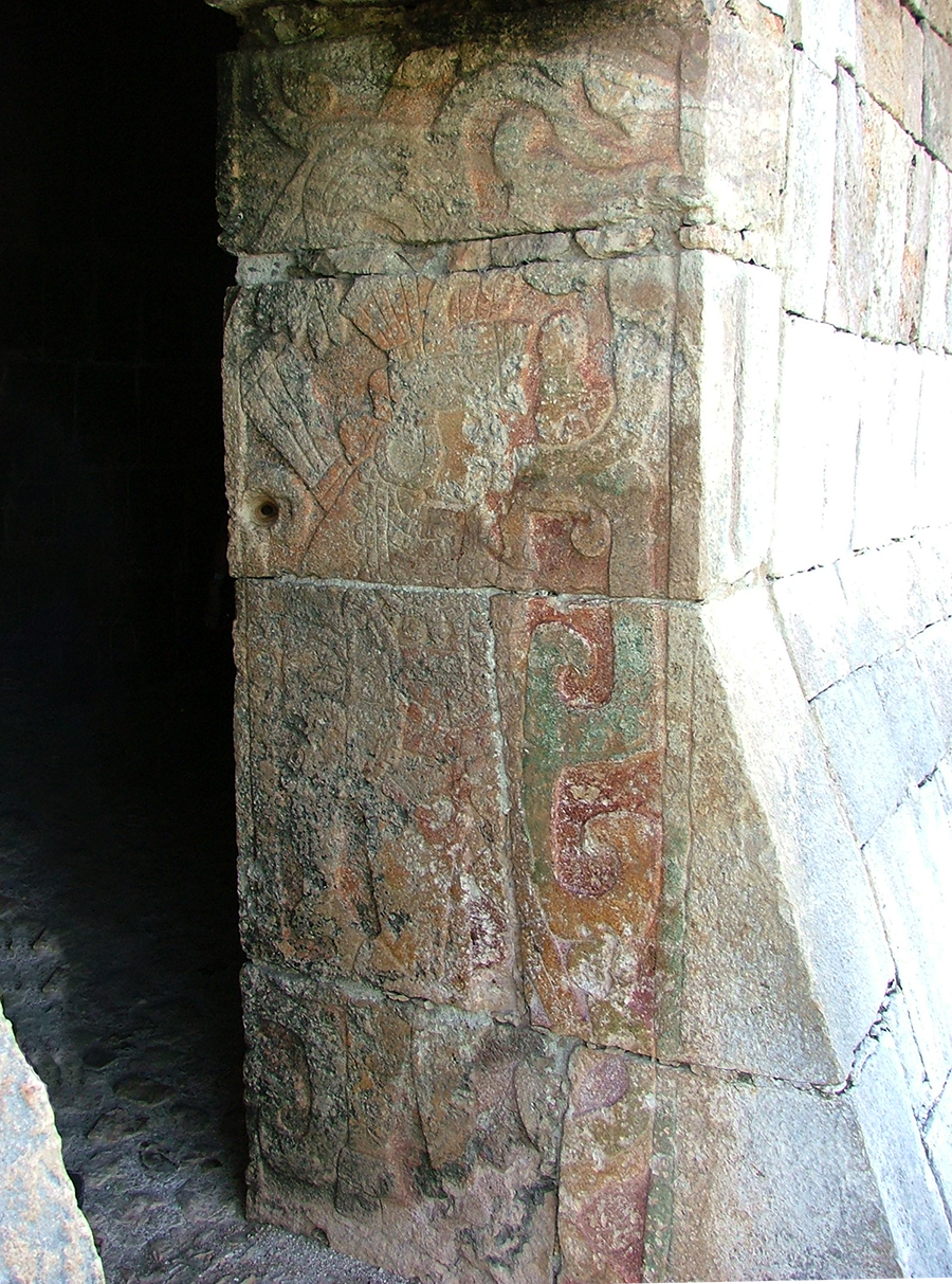 Doorjamb of the central doorway of the Temple of Kukulkan looking inward showing carved warrior and remnants of red, green and yellow paint