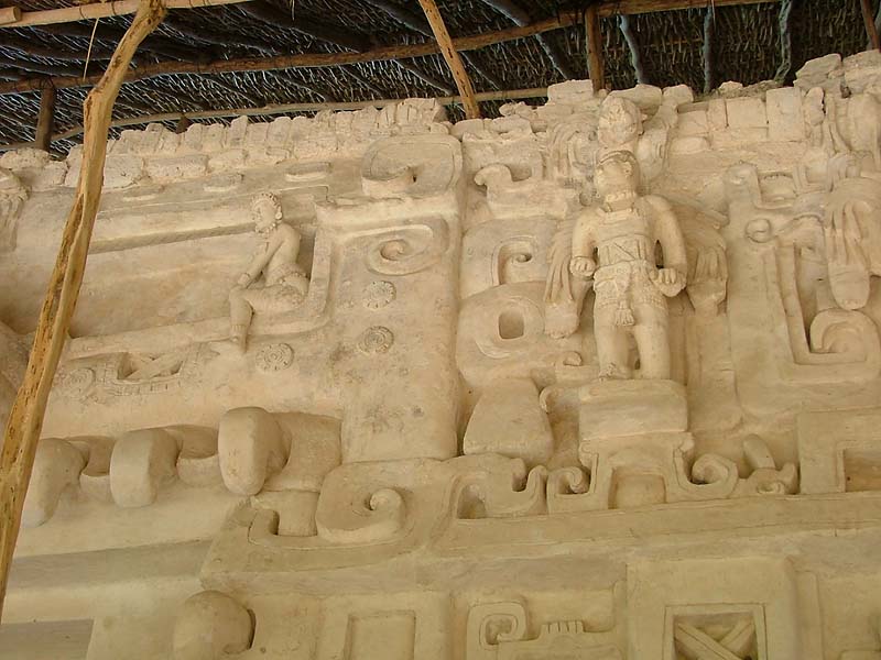 Chenes zoomorphic entrance, monster's right eye with figure sitting on its lower lid.