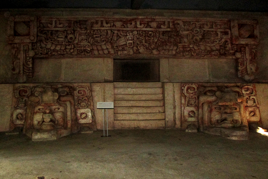 A color-enhanced reconstruction of the Late Preclassic stucco frieze from Substructure II-C, featuring the rain god Chac and the Maize God emerging from a Witz (earth monster) mask.