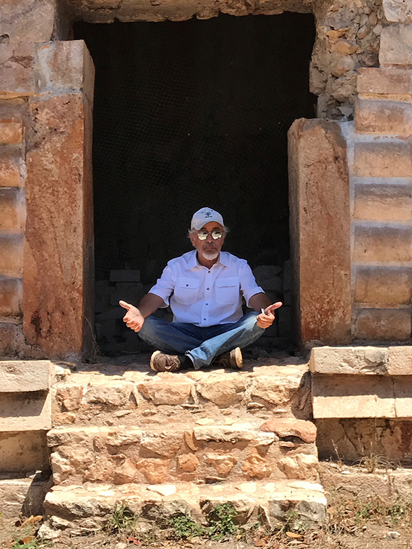 Archaeologist Tomás Gallareta seated in the doorway of the old throne room at Labna