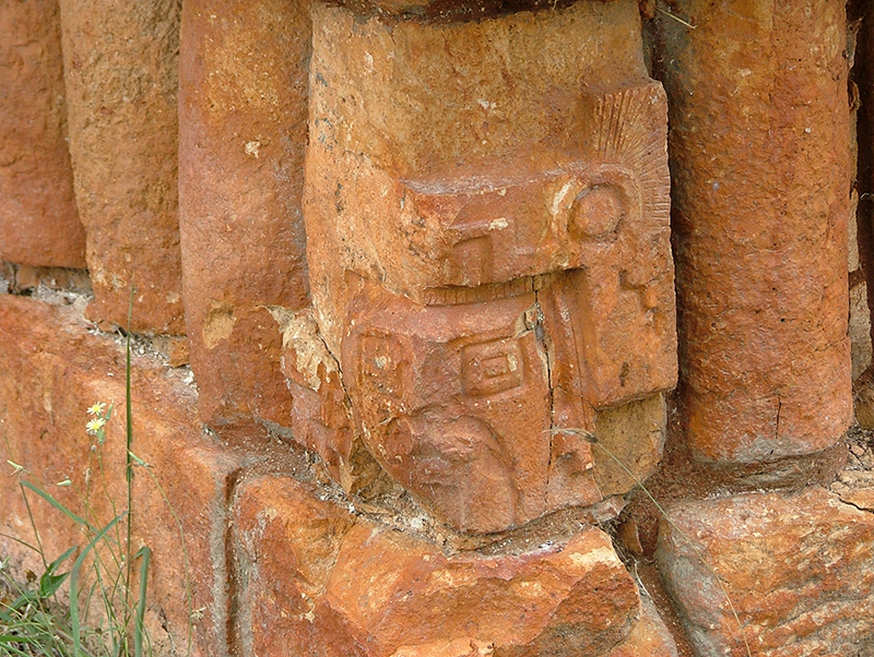 Ancestor figure carved into the basal corner molding below the Vision Serpent at Labna