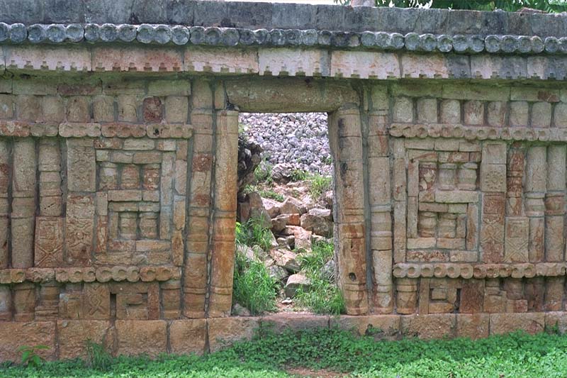 Ornate wall with mosaic stone design framing a doorway