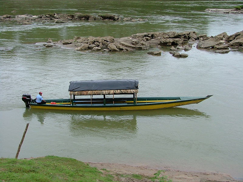 Maya boatman navigating a motorized lancha